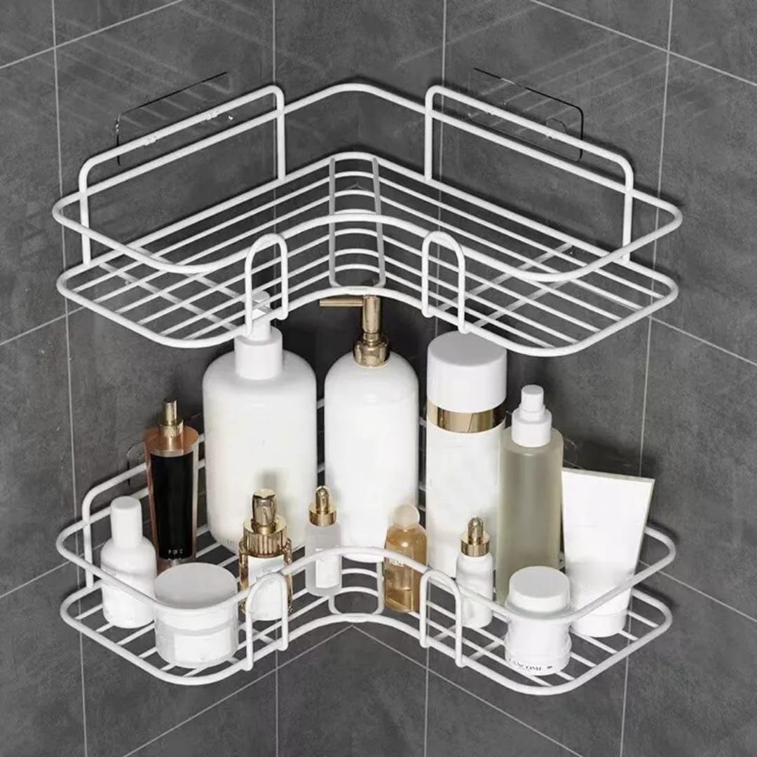 White wire corner shelves on grey tiles holding various skincare bottles and jars.