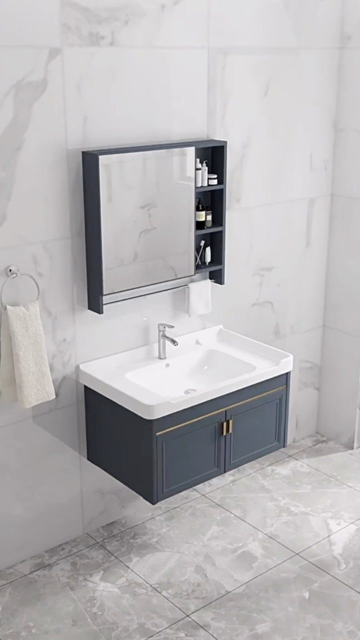 Grey bathroom vanity with white sink and mirror cabinet with side open shelving.