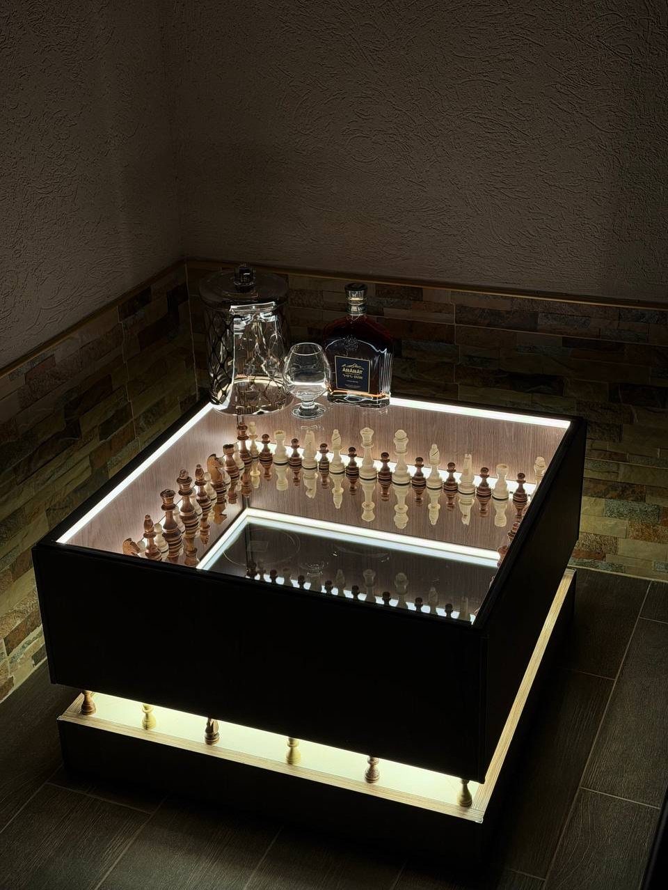 Illuminated chess board coffee table with pieces and glassware in a living room