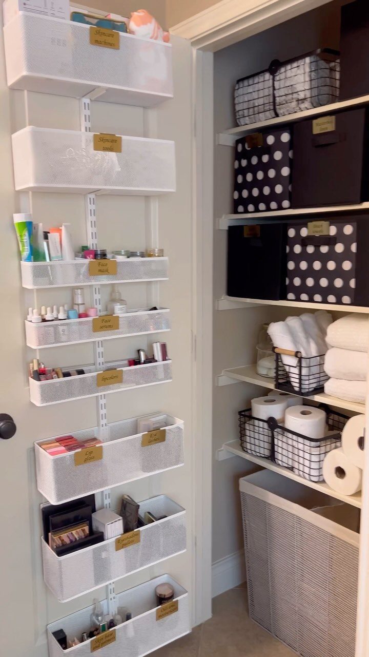 White over-the-door organizer with mesh bins holding toiletries on a closet door.