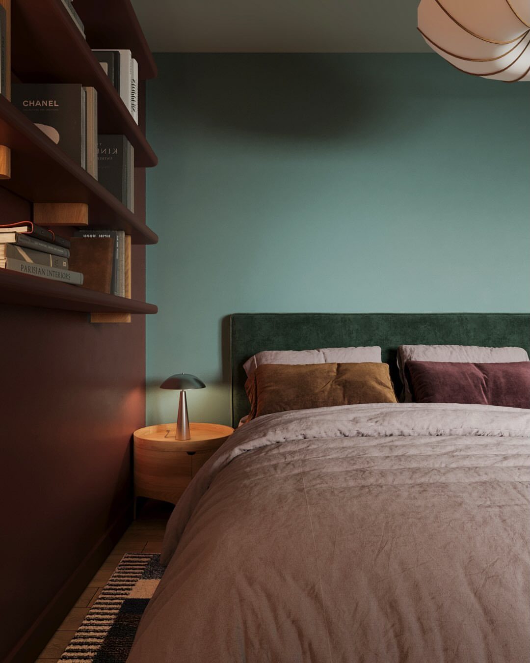 Bedroom with burgundy and teal colorblocked walls and a green velvet headboard