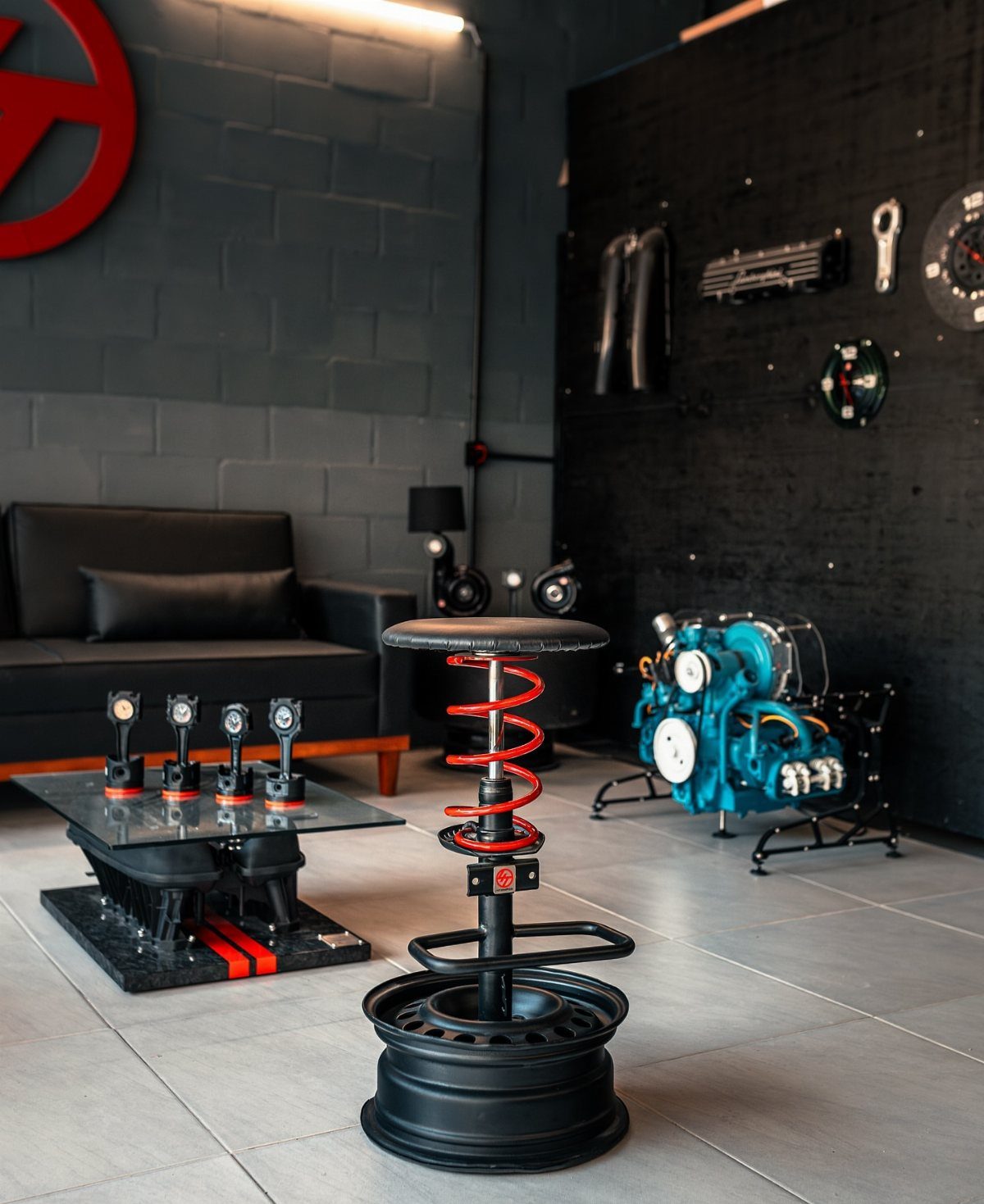Modern garage workshop with automotive-themed furniture and a blue engine on display.