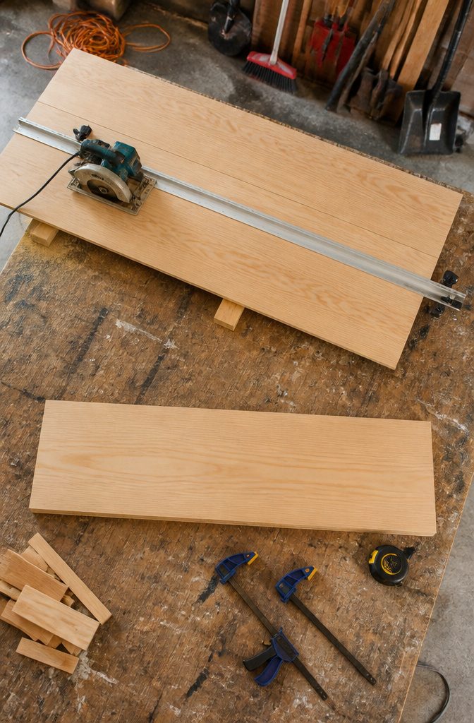Circular saw and Rip Cut guide cutting plywood on work supports