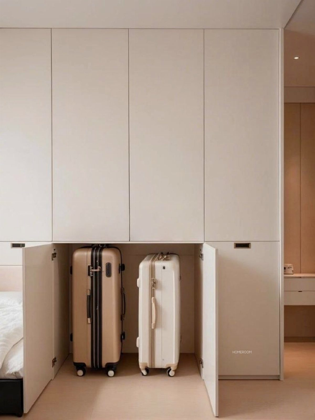 Two suitcases stored inside a built-in white cabinet in a minimalist room.