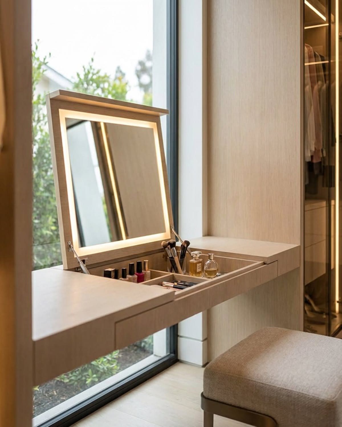 LED makeup desk with flip-top mirror and organized cosmetic storage in light wood.