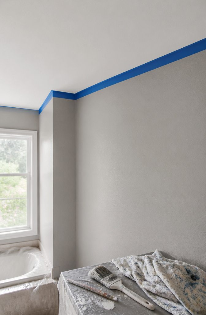 Painter's tape along the edge where the ceiling meets the wall.
