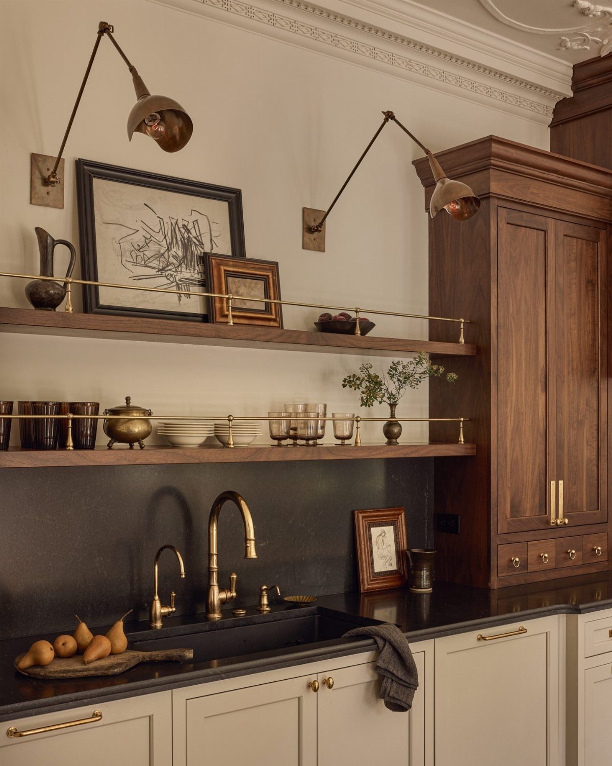 Wooden kitchen cabinets with doors paired with floating open shelves and gold accents.