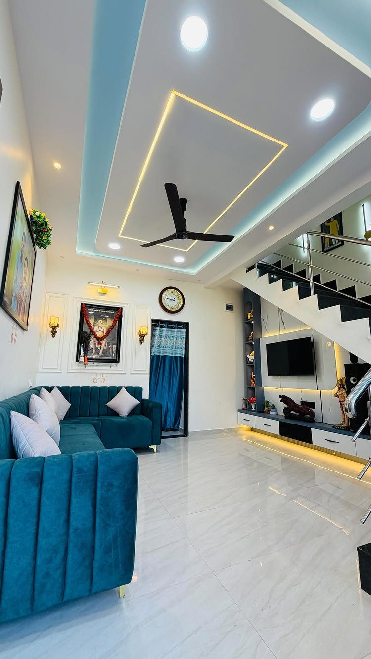 Built-in TV center located in the space beneath a modern white staircase.