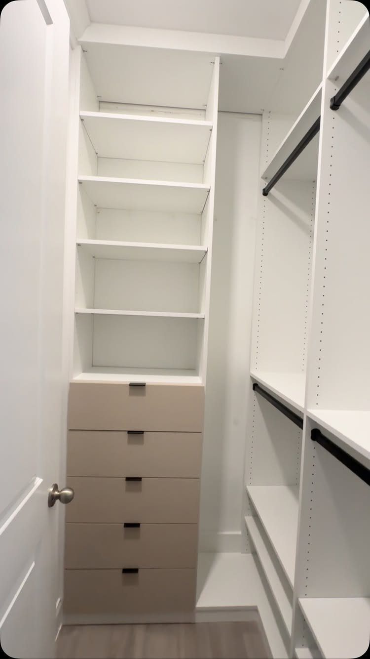 White reach-in closet with a stack of tan drawers and open white shelving.