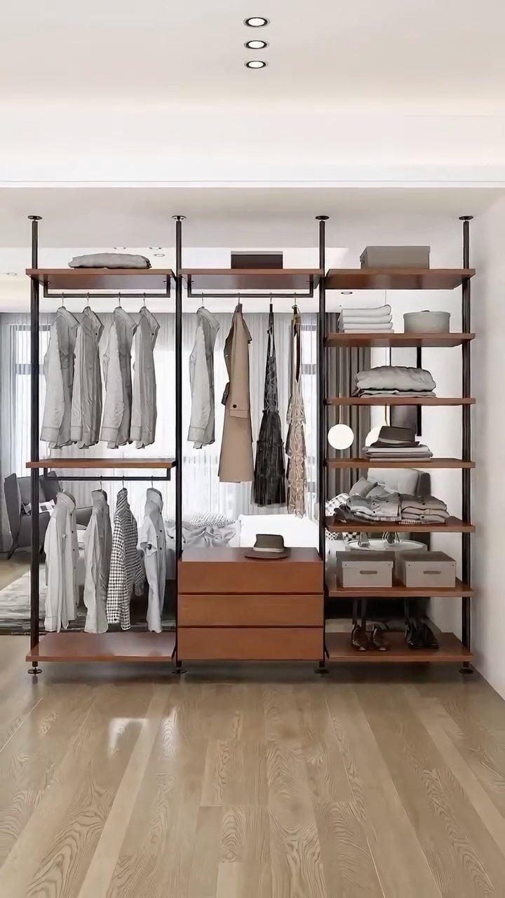 Open wall unit closet with brown wooden shelves, hanging clothes, and integrated drawers.
